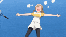 a girl laying on a tennis court with her arms outstretched and a tennis racquet in the background
