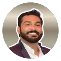 a man with a beard is smiling and wearing a suit and white shirt