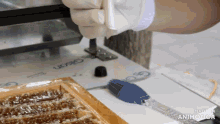 a person is using a machine that says made in animatica on it