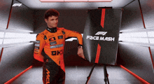 a man in a mclaren racing suit is holding a sign that says face mash