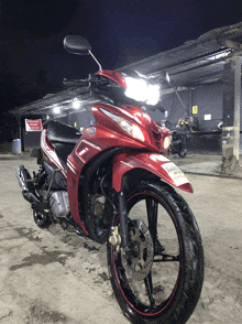 a red motorcycle is parked in front of a building
