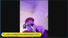 a man wearing headphones and a red hat is singing into a microphone .