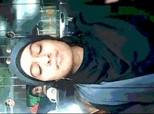 a woman wearing a hijab is smiling with her eyes closed .