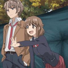 a boy and a girl are standing next to each other and the girl is waving