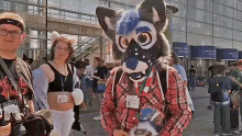 a man in a furry costume stands in front of a building with a sign that says ' wasserwelt ' on it