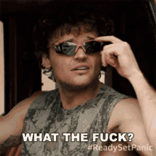 a man wearing sunglasses and a tank top is asking what the fuck