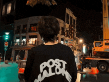 a person wearing a black post malone sweatshirt