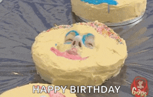 a birthday cake with a baby 's face on it .