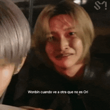 a close up of a person 's face with the words wonbin cuando ve a otra que no es ori
