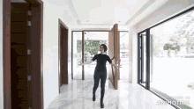 a woman is standing in a hallway with the words made in animatica written on the bottom