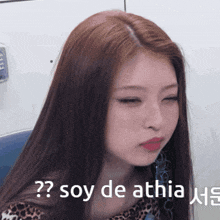 a close up of a woman 's face with the words " soy de athia " written on the bottom