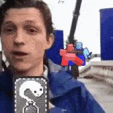 a man in a blue jacket holds a card that says ' s ' on it