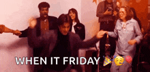 a group of people are dancing in a room with the words `` when it friday '' in the corner .
