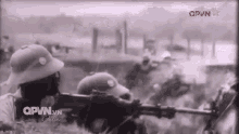 a black and white photo of a group of soldiers with qpvn.vn written on the bottom