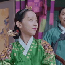 a woman in a green costume with a crown on her head has the name fanyonifan written below her