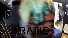 a blurred image of a person with the word ratio written in black