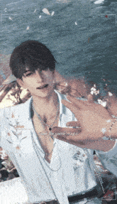 a man in a white shirt with a necklace and a bracelet says time for some magic