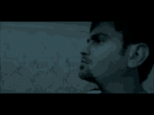 a close up of a man 's face in a dark room .
