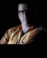 a man with glasses is behind a sign that says 130