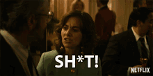 a woman in a green dress says " shot " in front of a man in a suit