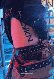 a person has a tattoo on their side that says " nkf "