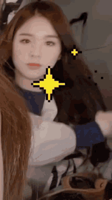 a close up of a woman 's face with a pixel art star in her hair