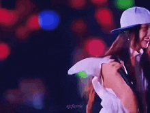 a blurry picture of a woman wearing a baseball cap and a white shirt