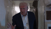 a man in a suit and white shirt is talking