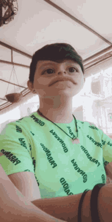 a young boy wearing a green shirt that says donald on it