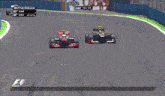 two racing cars are on a race track and one has a ham logo on the side