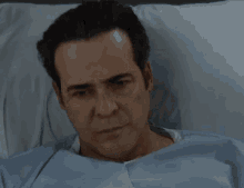 a man in a hospital bed with a bandage on his head .