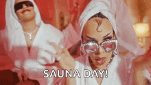 a woman in a bathrobe with a towel around her head is dancing in a room .