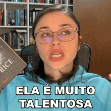 a woman wearing glasses is holding a book that says rice on it