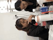 two women sitting at a table with a coca cola bottle