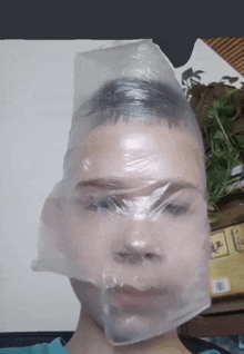 a boy with a plastic bag over his head