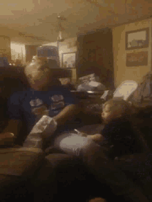 a man and a child are sitting on a couch in a room