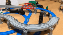a toy train set with a bridge and a tunnel