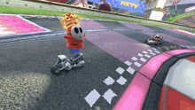 a cartoon character riding a motorcycle on a track with a sign that says mktv