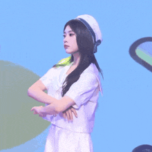 a girl wearing a sailor hat and a white shirt