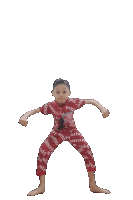 a young boy in a red shirt and pants with the word supreme on them