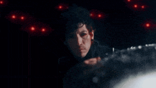 a close up of a person 's face with red eyes and blood on it .