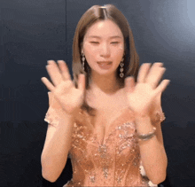 a woman in a very revealing dress is waving her hands in the air
