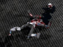 a man in a red helmet is laying on a brick floor