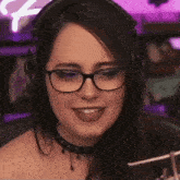 a close up of a woman wearing glasses and headphones .