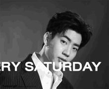 a black and white photo of a man in a suit with the words very saturday below him