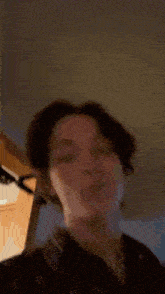 a blurry picture of a person 's face with a blurred background