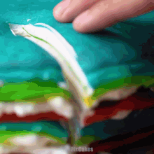 a close up of a person 's hand on a blue background with the words mr.cakes on the bottom