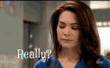 a woman in a blue scrub has the word really written on her face
