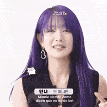a woman with purple hair is making a funny face while wearing earrings .
