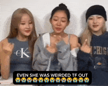 three women are sitting next to each other and one of them is wearing a calvin klein tank top